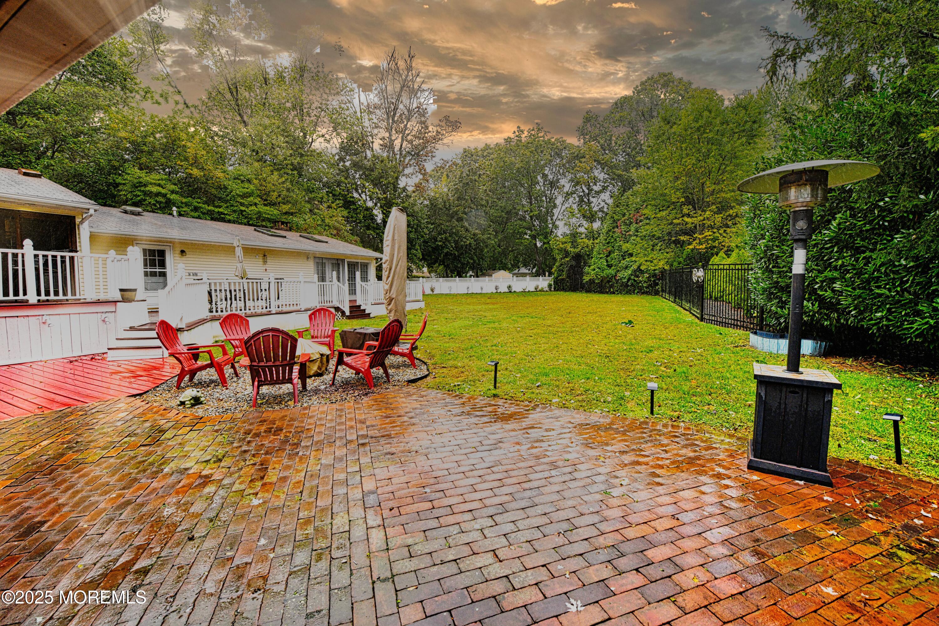 17 High Point Road Lincroft, NJ 07738 - Photo 8 of 39 a view of a backyard with a patio and fire pit