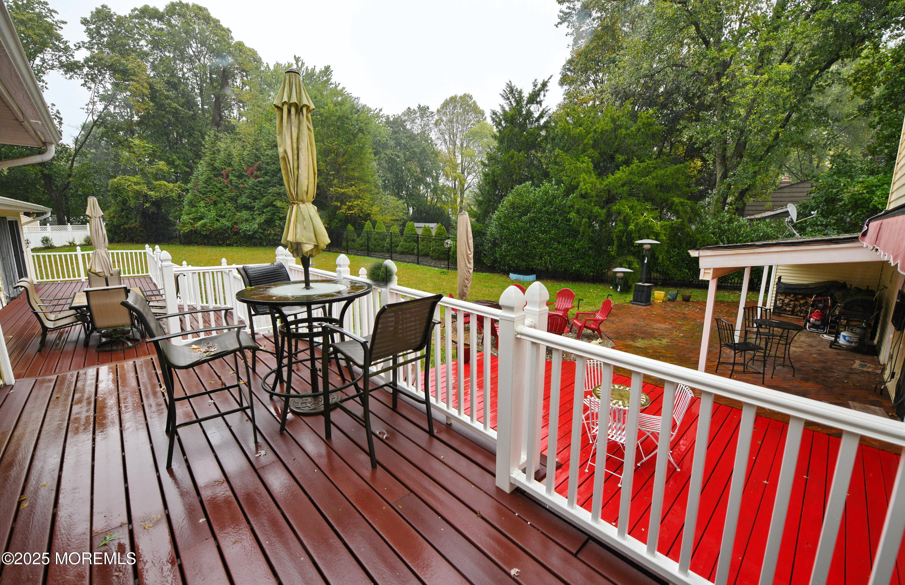 17 High Point Road Lincroft, NJ 07738 - Photo 10 of 39 a view of deck with chairs and couches with wooden floor and fence