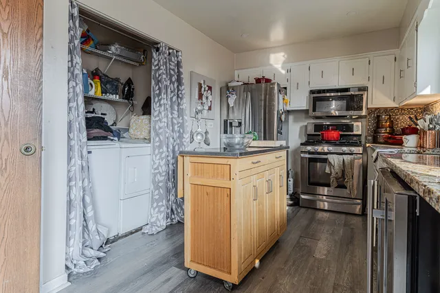 a kitchen with stainless steel appliances a stove refrigerator sink and microwave