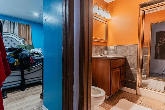 a view of a rooftop deck with couch and chairs