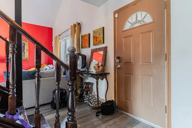 a view of an entryway with wooden floor