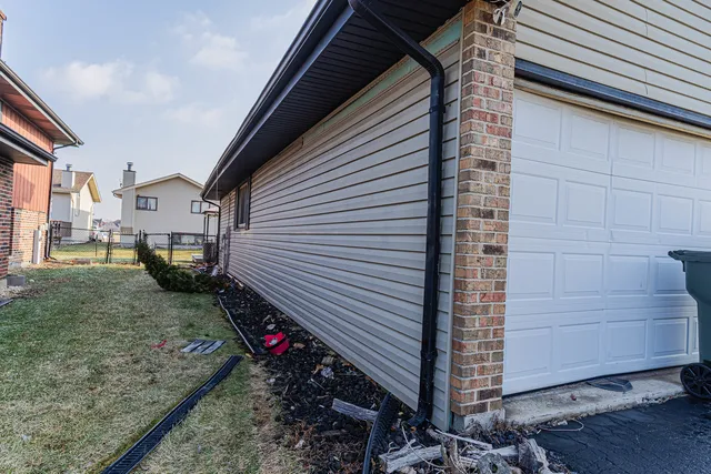 an aerial view of a house with swimming pool garden and patio