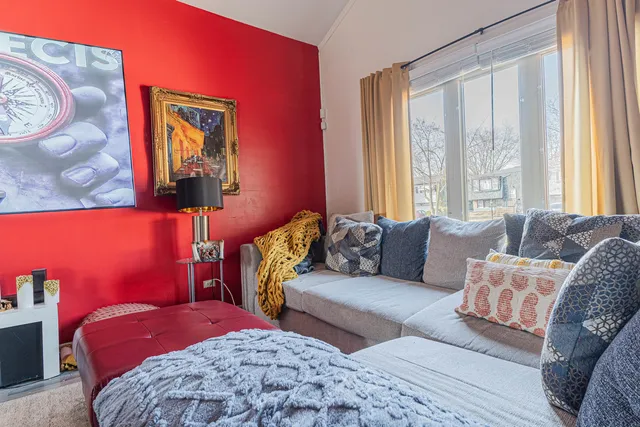 a bedroom with a bed couch and next to a window