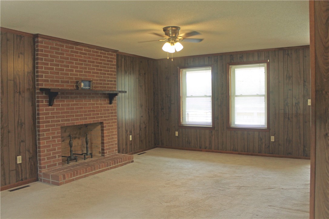 1007 O Neal Street Belton, SC 29627 - Photo 11 of 25 This living area features a brick fireplace, creating a warm and inviting atmosphere.