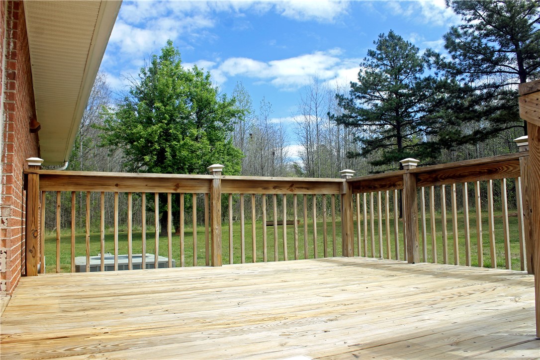 1007 O Neal Street Belton, SC 29627 - Photo 18 of 25 Step out onto this spacious outdoor deck, perfect for peaceful moments amidst lush greenery.