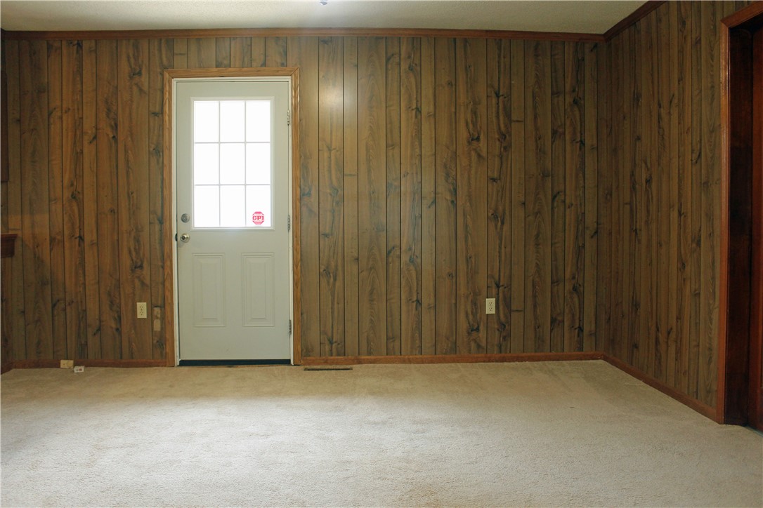 1007 O Neal Street Belton, SC 29627 - Photo 9 of 25 This cozy space features rustic wood paneling, offering a warm and inviting atmosphere.
