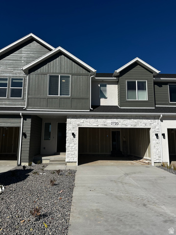 2720 West Aurora Avenue Mapleton, UT 84664 - Photo 1 of 11 View of front facade with stone siding, a garage, concrete driveway, a porch, and board and batten siding