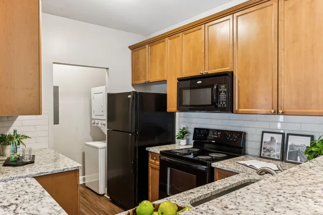 a kitchen with a stove a refrigerator and a microwave