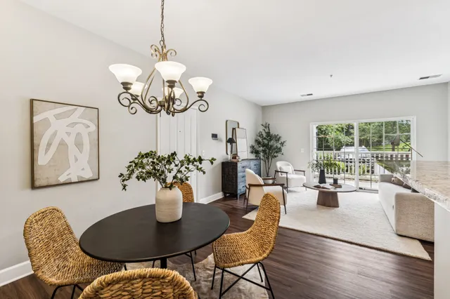 a view of a dining room with furniture wooden floor and chandelier