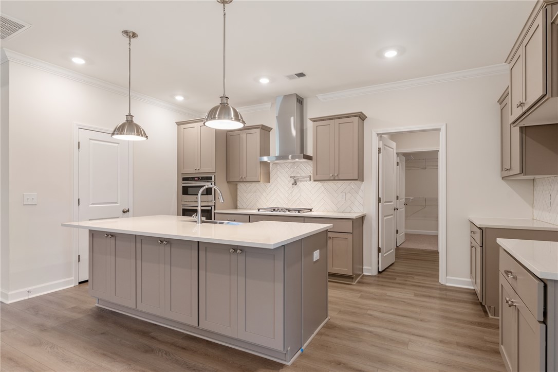 110 Lakeside Drive Anderson, SC 29621 - Photo 13 of 34 This bright kitchen features an island, ample cabinetry, and sleek built-in appliances.