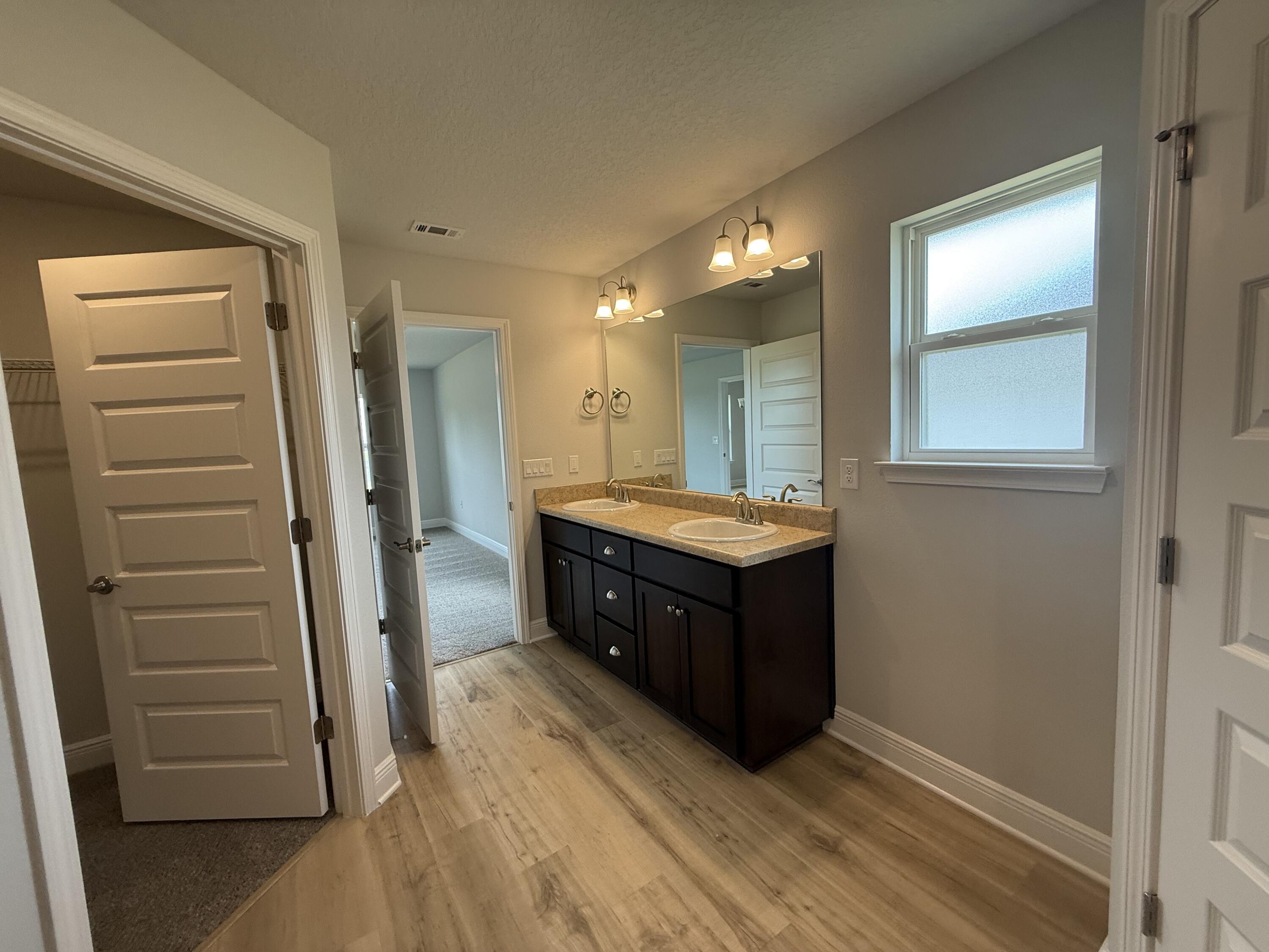 6000 Crocket Cove Crestview, FL 32539 - Photo 17 of 20 a bathroom with a sink a vanity and a mirror