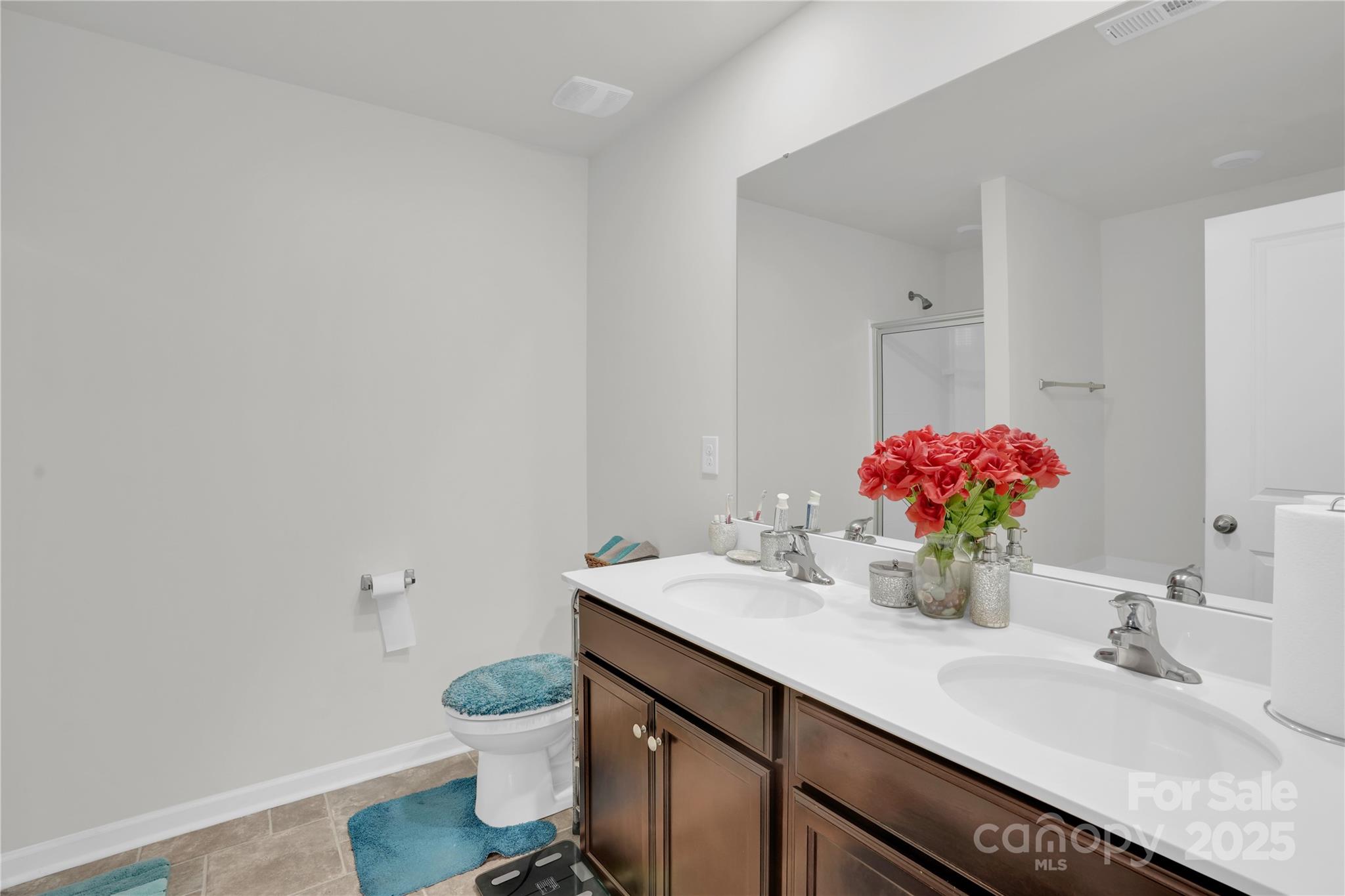 4918 Traynor Road Charlotte, NC 28216 - Photo 14 of 27 a bathroom with a granite countertop sink and a mirror with toilet