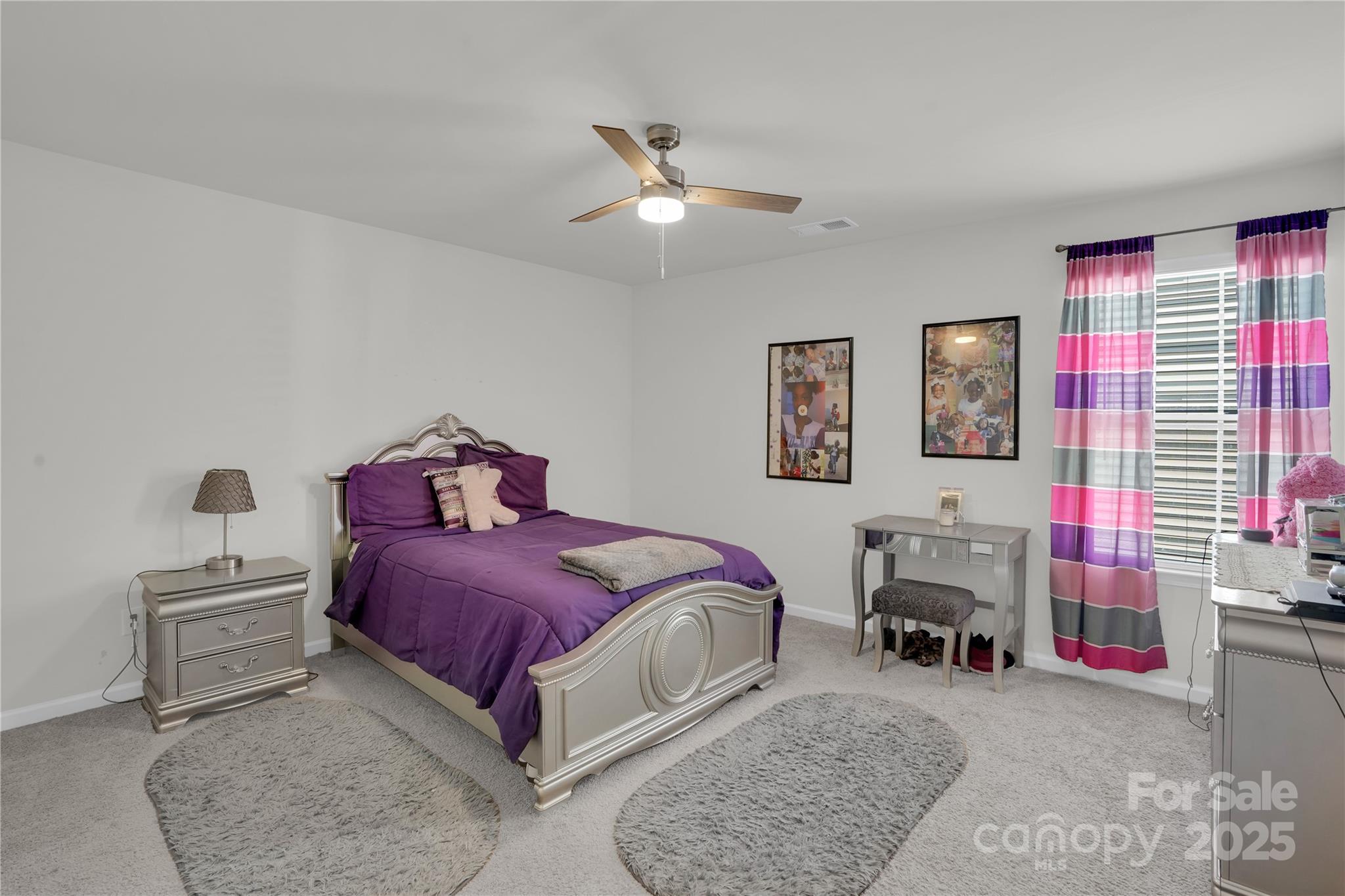 4918 Traynor Road Charlotte, NC 28216 - Photo 18 of 27 a spacious bedroom with a bed a couch and a chandelier