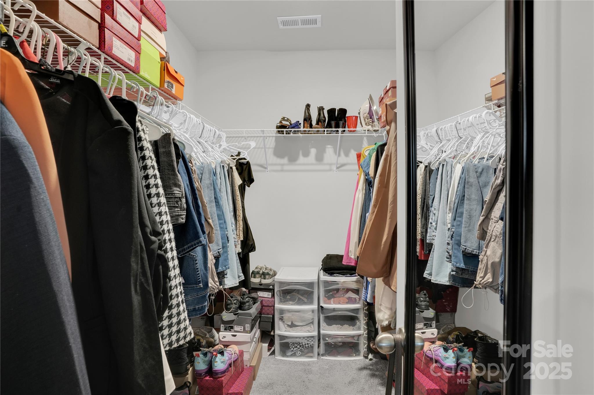 4918 Traynor Road Charlotte, NC 28216 - Photo 20 of 27 a view of walk in closet with clothes and shoes