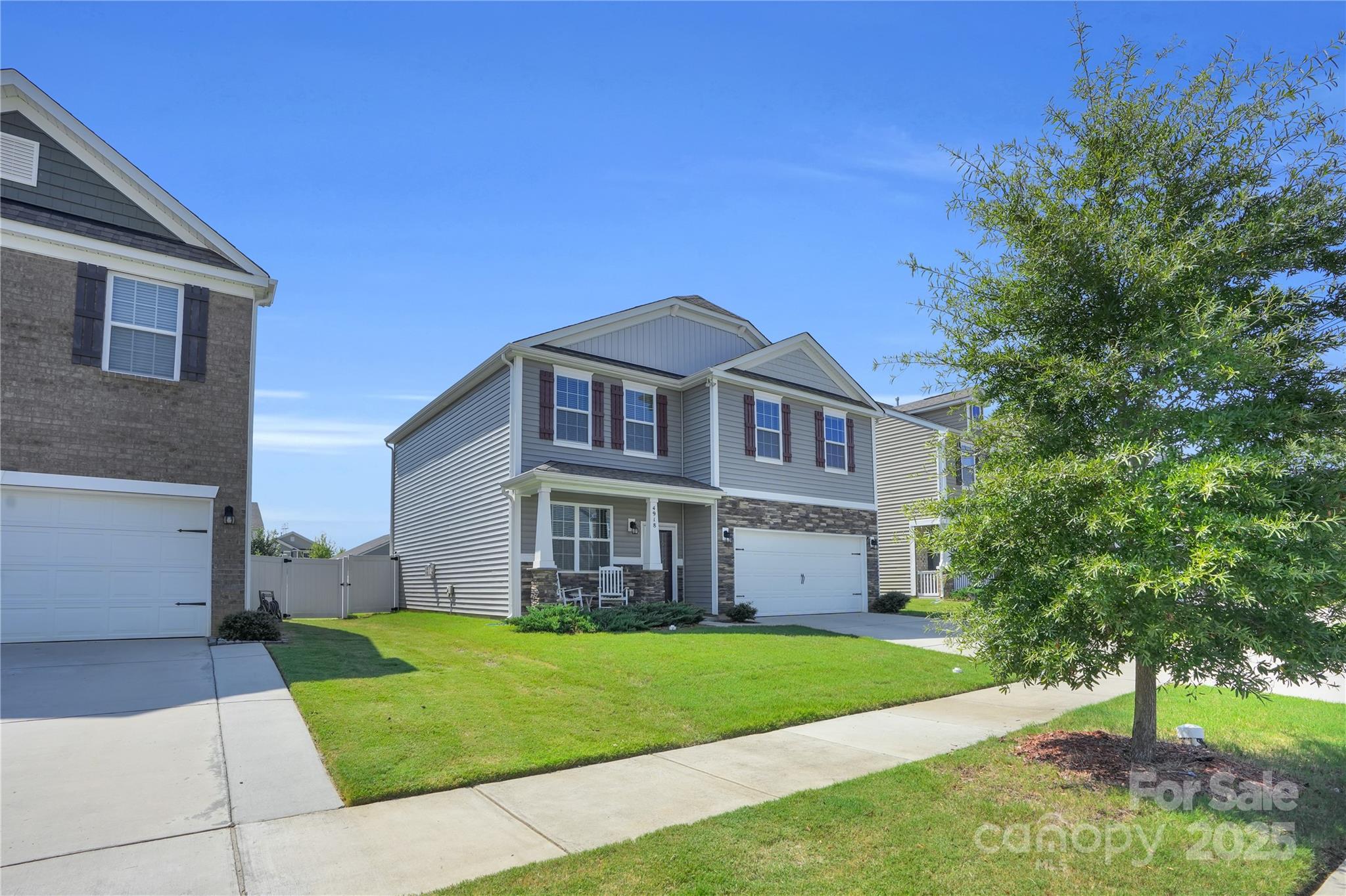 4918 Traynor Road Charlotte, NC 28216 - Photo 2 of 27 a front view of a house with a garden and trees