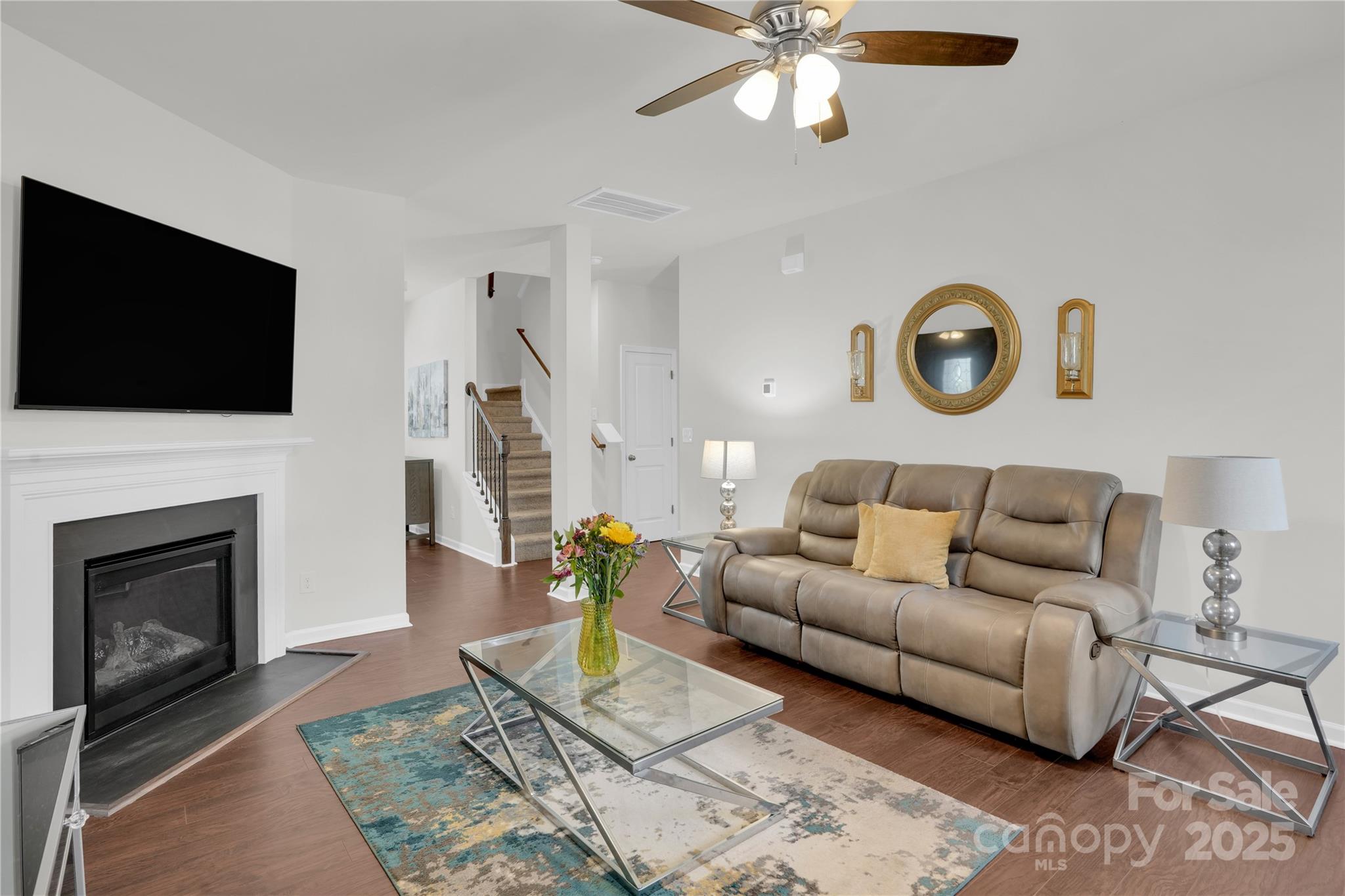 4918 Traynor Road Charlotte, NC 28216 - Photo 4 of 27 a living room with furniture a fireplace and a flat screen tv