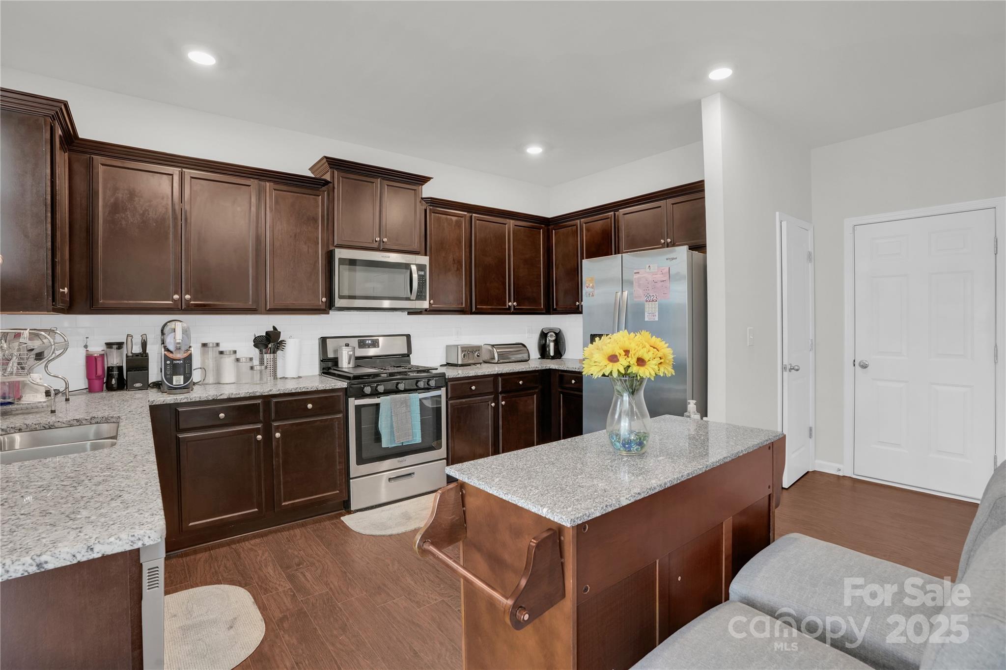 4918 Traynor Road Charlotte, NC 28216 - Photo 9 of 27 a kitchen with stainless steel appliances granite countertop a stove a sink dishwasher and a refrigerator with wooden cabinets
