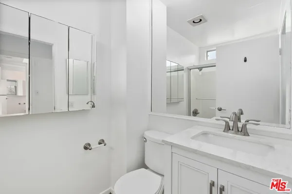 a bathroom with a sink toilet and vanity
