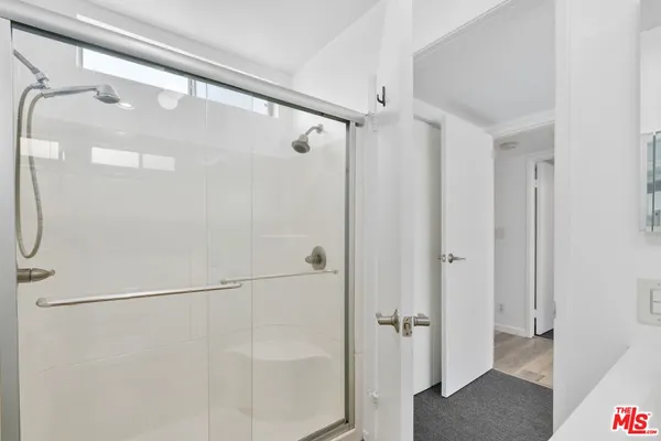 a bathroom with a glass shower door