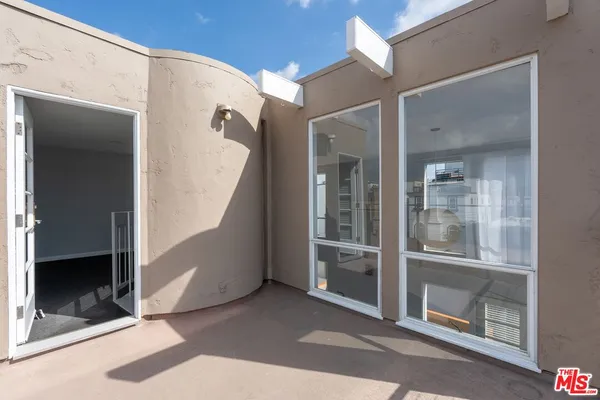 a view of a hallway with entryway window and front door
