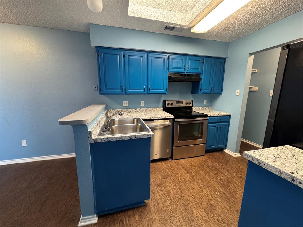 6259 Canyon Circle Fort Worth, TX 76133 - Photo 12 of 22 a kitchen with stainless steel appliances granite countertop a sink stove and refrigerator