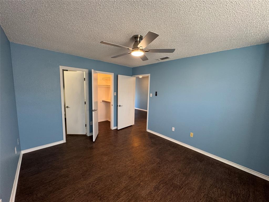 6259 Canyon Circle Fort Worth, TX 76133 - Photo 14 of 22 a view of an empty room with window and a ceiling fan