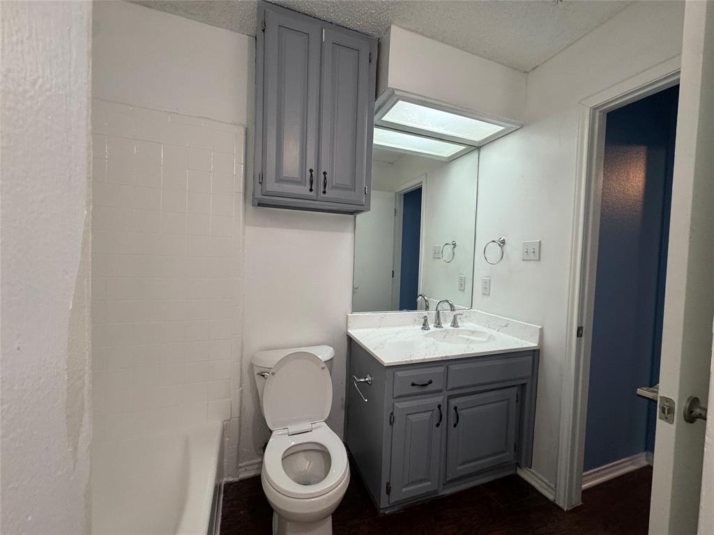 6259 Canyon Circle Fort Worth, TX 76133 - Photo 16 of 22 a bathroom with a toilet sink and mirror