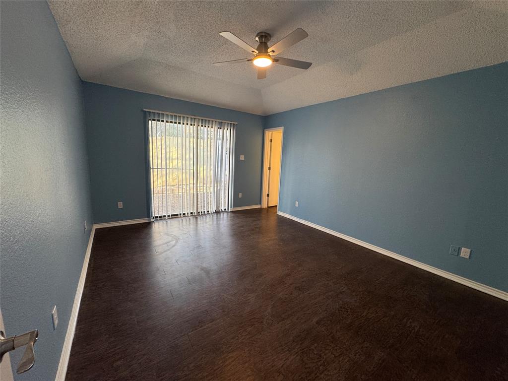 6259 Canyon Circle Fort Worth, TX 76133 - Photo 18 of 22 an empty room with wooden floor and windows
