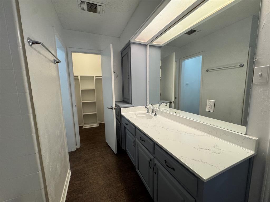 6259 Canyon Circle Fort Worth, TX 76133 - Photo 21 of 22 a bathroom with a sink a mirror and a shower