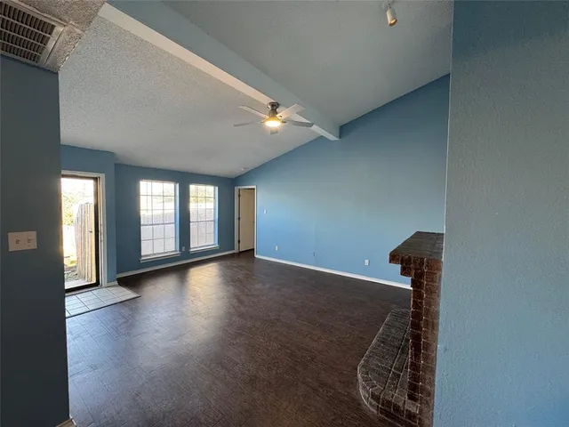 a view of a livingroom with wooden floor and a staircase