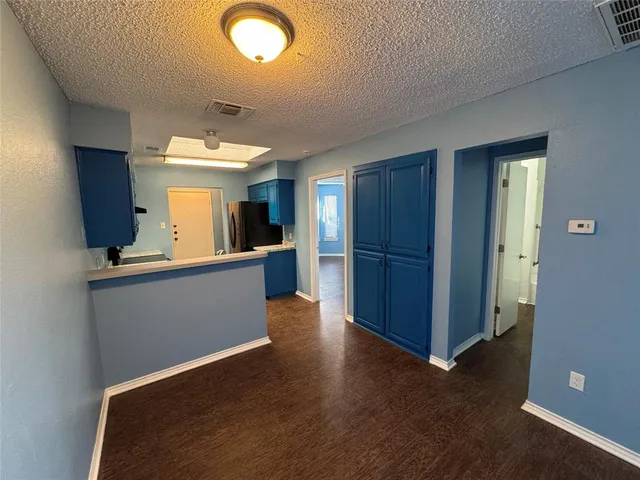 a view of a kitchen with wooden floor and a kitchen