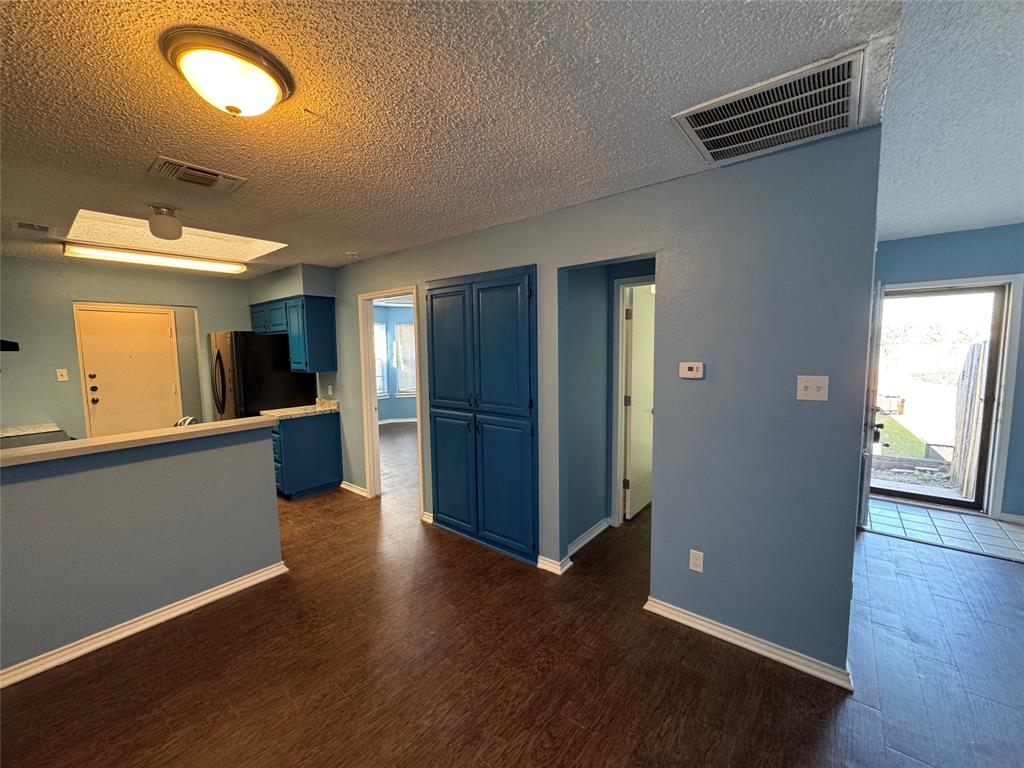 6259 Canyon Circle Fort Worth, TX 76133 - Photo 9 of 22 an empty room with wooden floor and windows