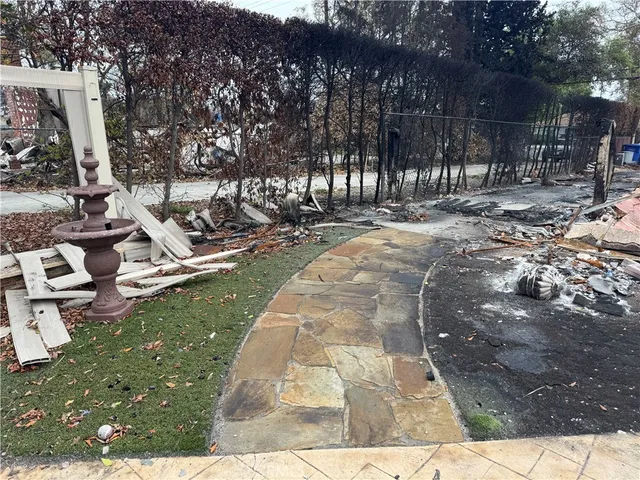 a view of a house with backyard space and sitting area