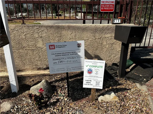 a view of a yard with wooden fence
