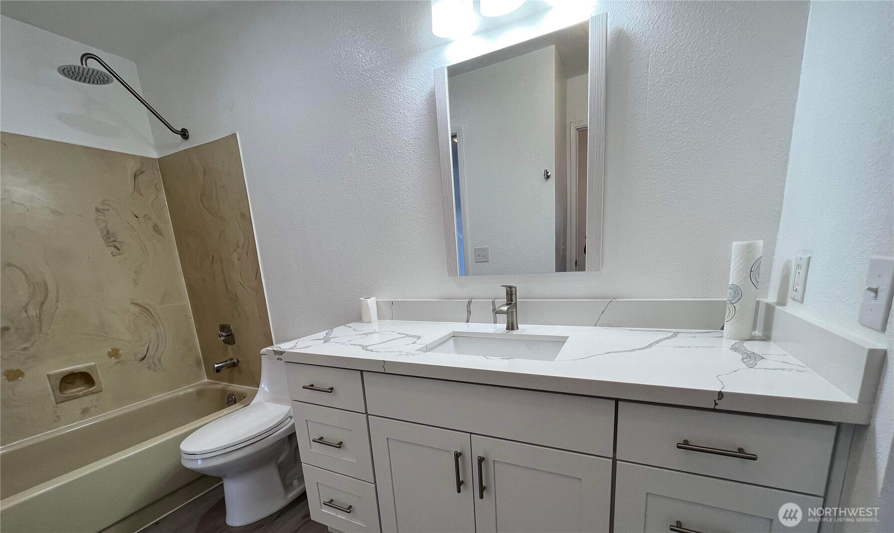 1175 Harrington Place Northeast, Unit 214 Renton, WA 98056 - Photo 15 of 16 a bathroom with a sink a toilet and shower