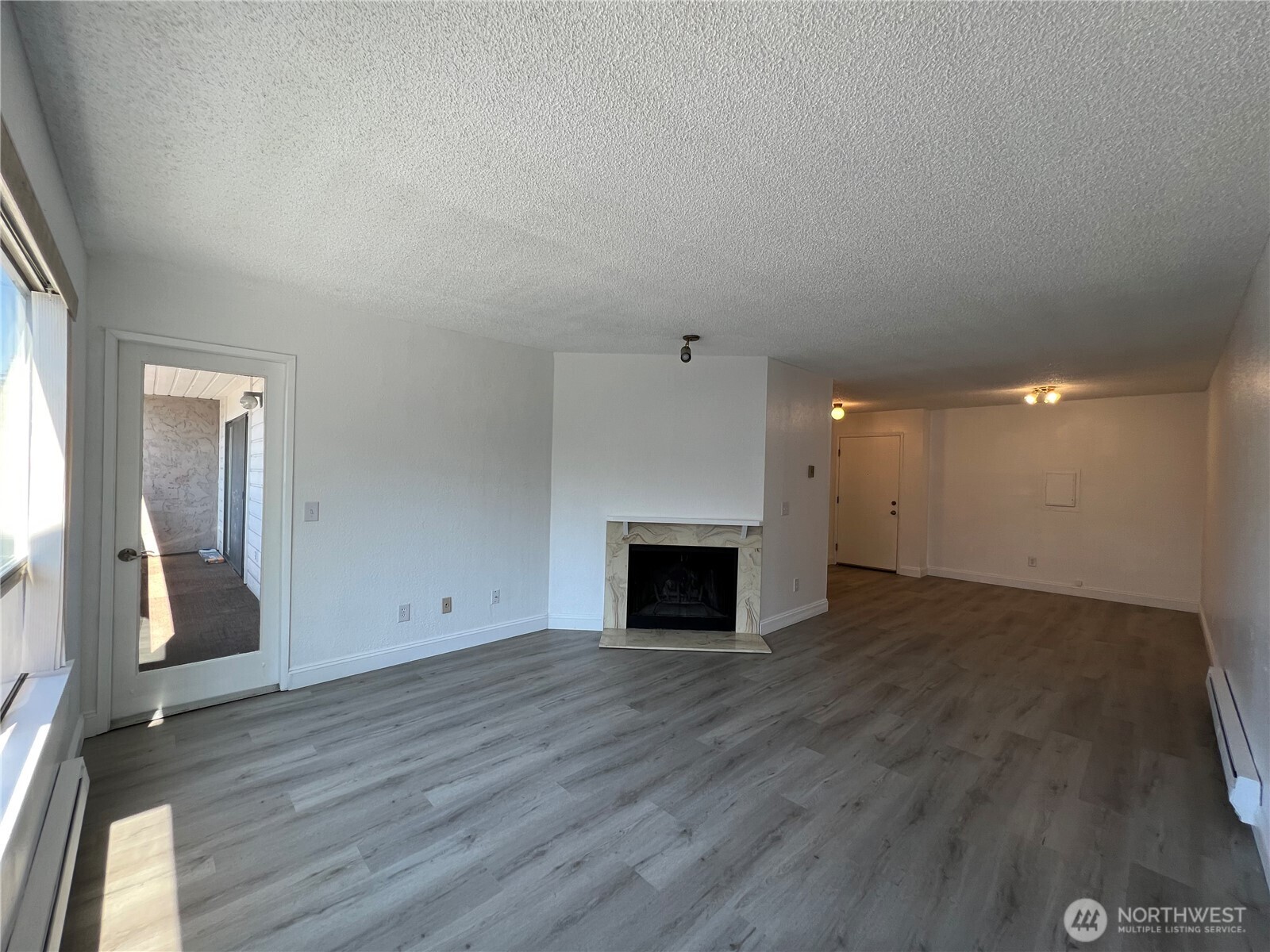 1175 Harrington Place Northeast, Unit 214 Renton, WA 98056 - Photo 5 of 16 a view of empty room with wooden floor