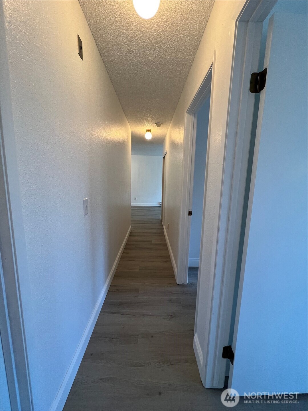 1175 Harrington Place Northeast, Unit 214 Renton, WA 98056 - Photo 6 of 16 a view of a hallway with wooden floor