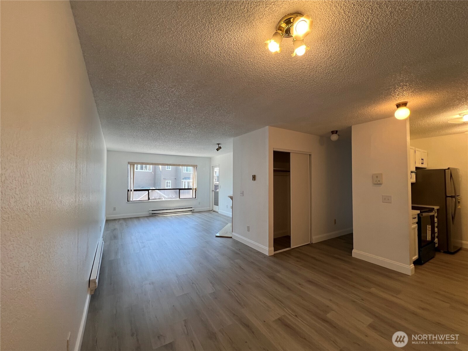 1175 Harrington Place Northeast, Unit 214 Renton, WA 98056 - Photo 7 of 16 a view of empty room with wooden floor