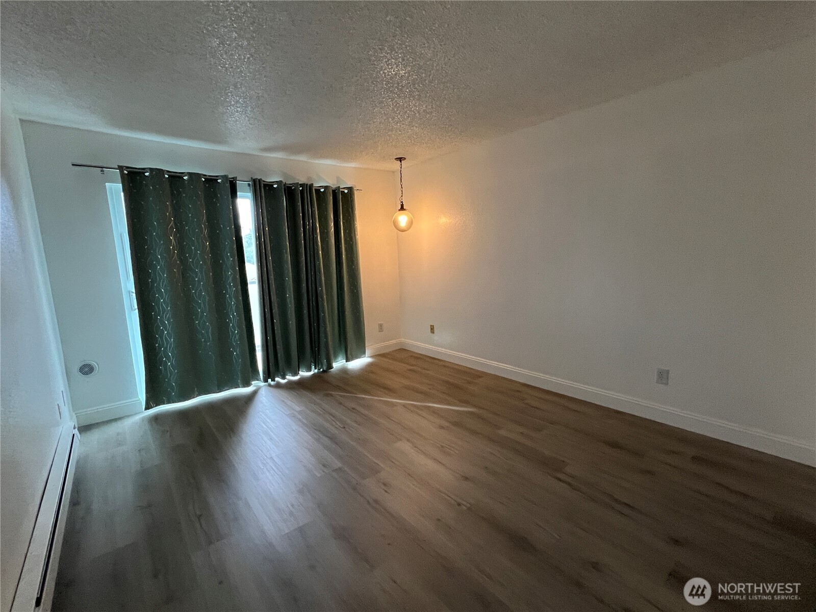 1175 Harrington Place Northeast, Unit 214 Renton, WA 98056 - Photo 8 of 16 an empty room with wooden floor and closet