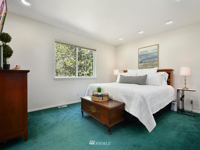 a bedroom with bed and a window