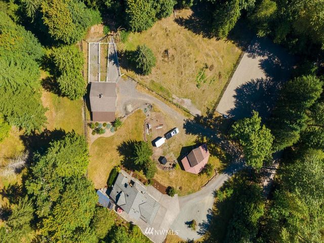 an aerial view of a house with a yard and garden