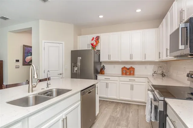 a kitchen with a sink cabinets and refrigerator