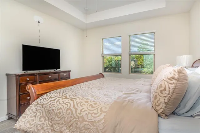 a bedroom with a bed and a flat screen tv