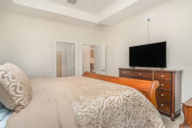 a bedroom with a bed and a flat screen tv