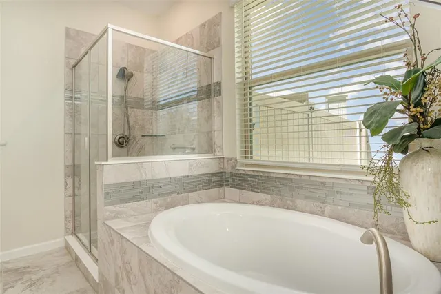 a bathroom with bathtub and window