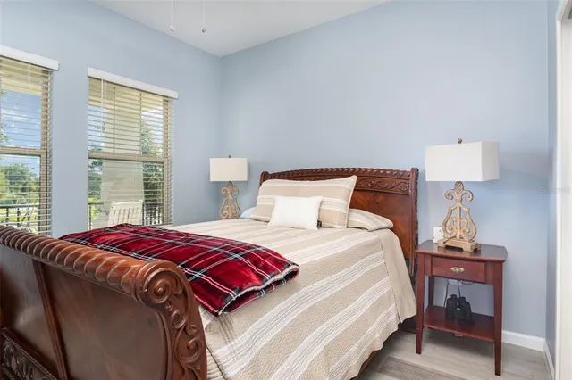 a bedroom with a bed and a lamp on table