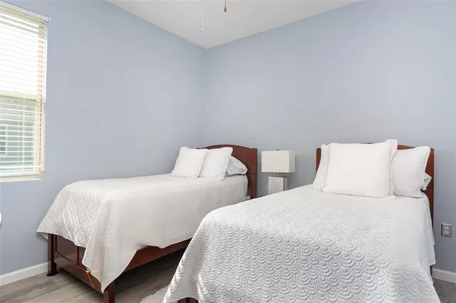 a bedroom with two beds and a night stand