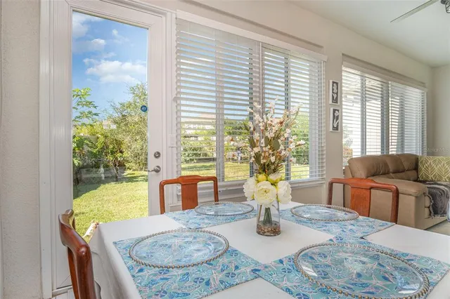 a dining room with furniture a large window and dining table