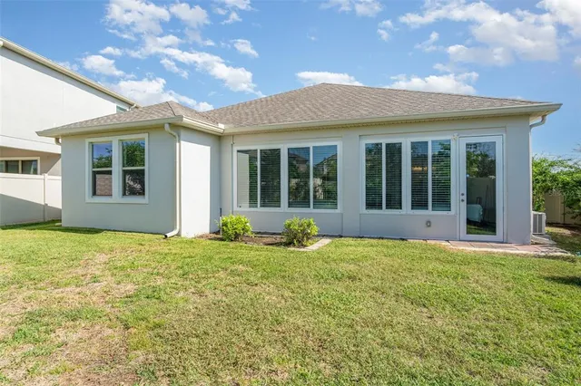 a view of a house with backyard and porch
