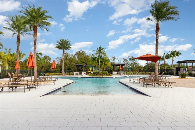 a view of a swimming pool with a table and chairs
